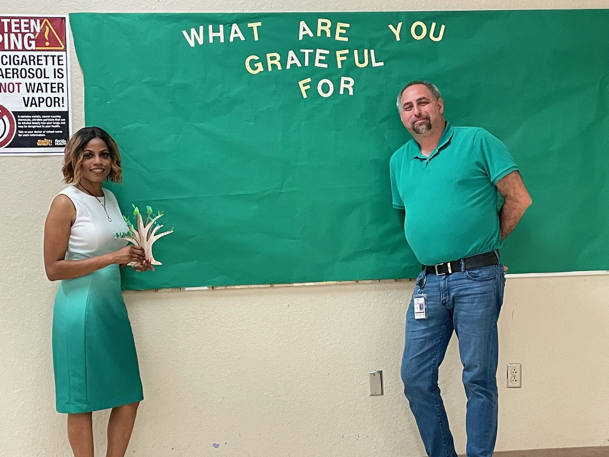 Pictured: Co-located Mental Health Professional Tawanna Richardson and Single School Culture Coordinator Cameron Simmons Ed. S, stand together wearing green for mental health awareness and trauma informed care month in May.