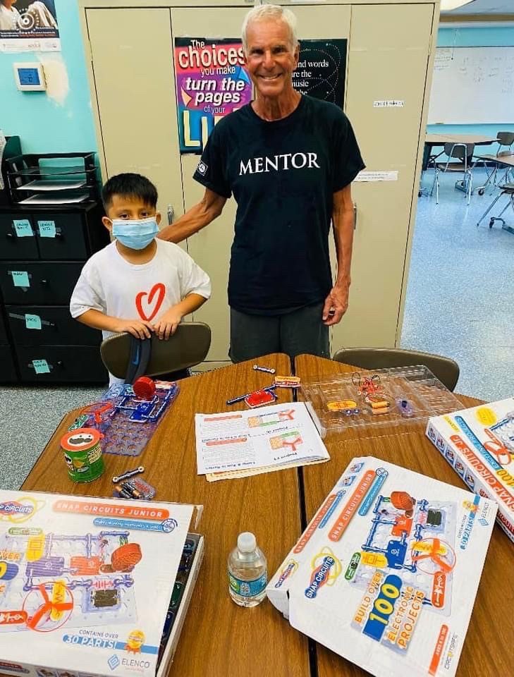 Mentor Andrew and Mentee Abraham build snap circuit kits