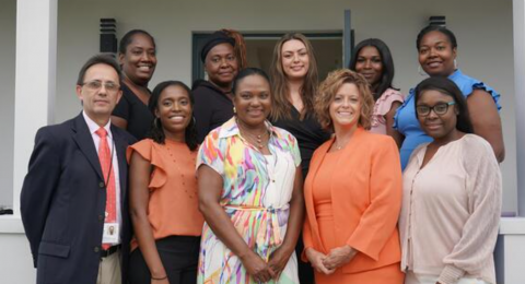 group of people standing in front  of new house